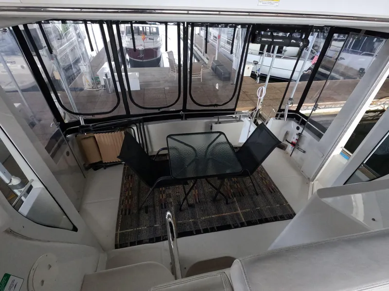 Slide: The Image of 2001 Carver 444 Cockpit Motor Yacht interior with table and chairs. - 35