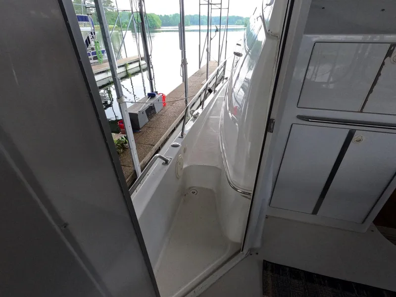Slide: The Image of 2001 Carver 444 Cockpit Motor Yacht, docked with a view of the water and marina. - 36