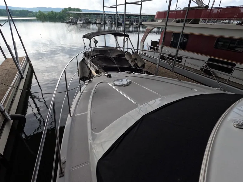 Slide: The Image of 2001 Carver 444 Cockpit Motor Yacht docked at a marina. - 37