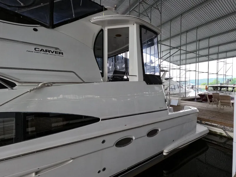 Slide: The Image of 2001 Carver 444 Cockpit Motor Yacht docked in a covered marina. - 4