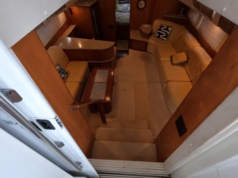 Slide: The Image of Interior of 2001 Carver 444 Cockpit Motor Yacht with beige seating and wooden accents. - 41