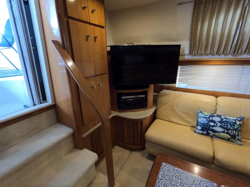 Slide: The Image of Interior of 2001 Carver 444 Cockpit Motor Yacht with TV, sofa, and stairs. - 42