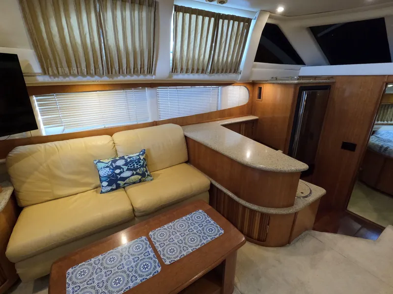 Slide: The Image of Interior of 2001 Carver 444 Cockpit Motor Yacht with beige sofa and wooden accents. - 43