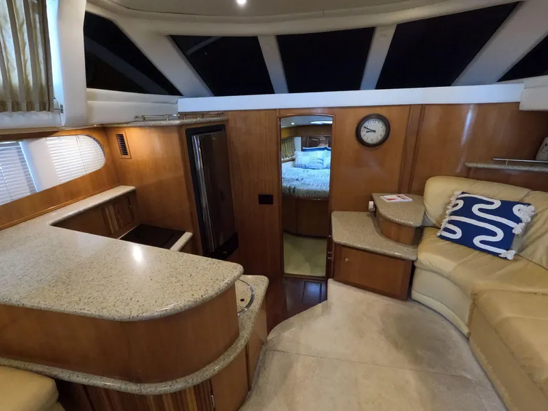 Slide: The Image of Interior of 2001 Carver 444 Cockpit Motor Yacht with modern kitchen and cozy seating area. - 44
