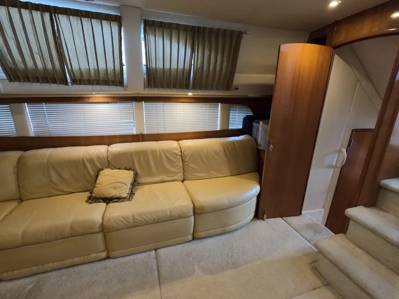 Slide: The Image of Interior of 2001 Carver 444 Cockpit Motor Yacht with beige leather sofa and wooden accents. - 46