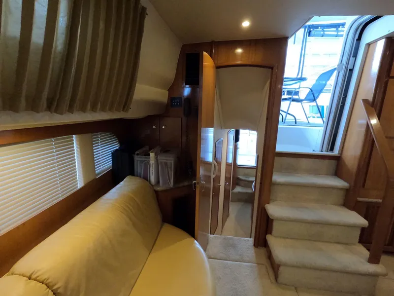 Slide: The Image of Interior of 2001 Carver 444 Cockpit Motor Yacht with beige seating and wooden finishes. - 47