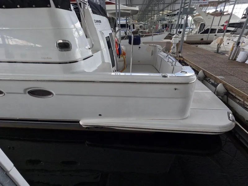 Slide: The Image of 2001 Carver 444 Cockpit Motor Yacht docked at marina. - 5