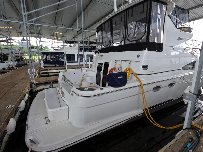 Slide: The Image of 2001 Carver 444 Cockpit Motor Yacht docked in a covered marina. - 7