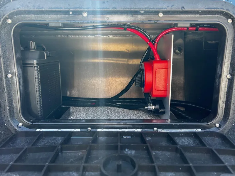 Slide: The Image of 2024 Fish Rite Angler boat battery compartment with wiring and components. - 19