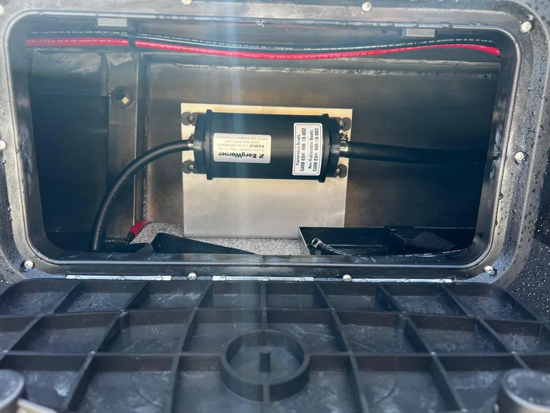 Slide: The Image of 2024 Fish Rite Angler 18 storage compartment with wiring and equipment. - 20