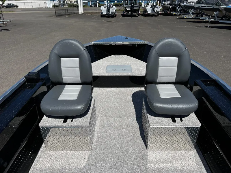 Slide: The Image of 2024 Fish Rite Angler boat interior with two grey seats on diamond plate bases. - 22