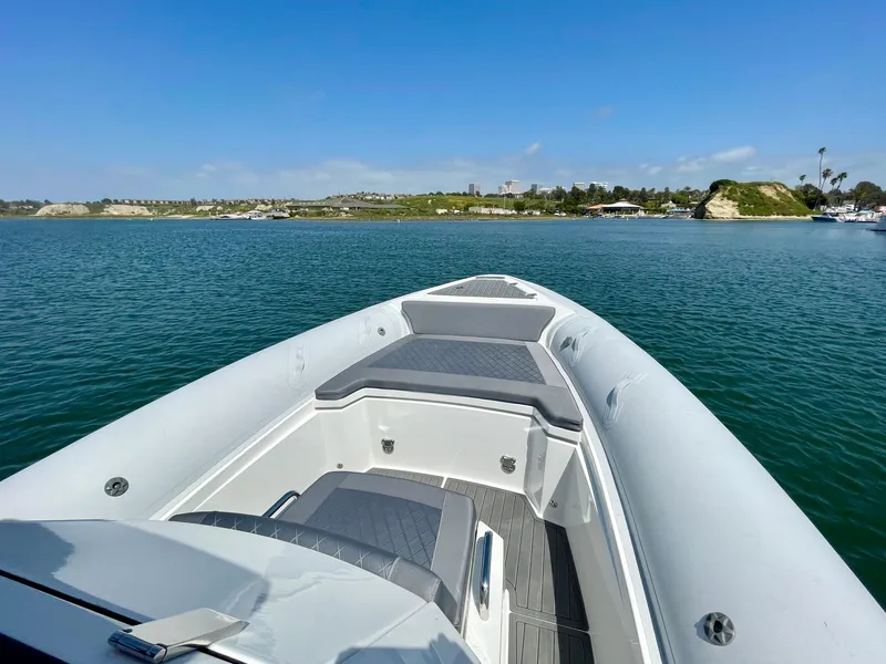 Slide: The Image of 2024 Northstar Orion 8 boat on calm water with scenic shoreline in the background. - 13
