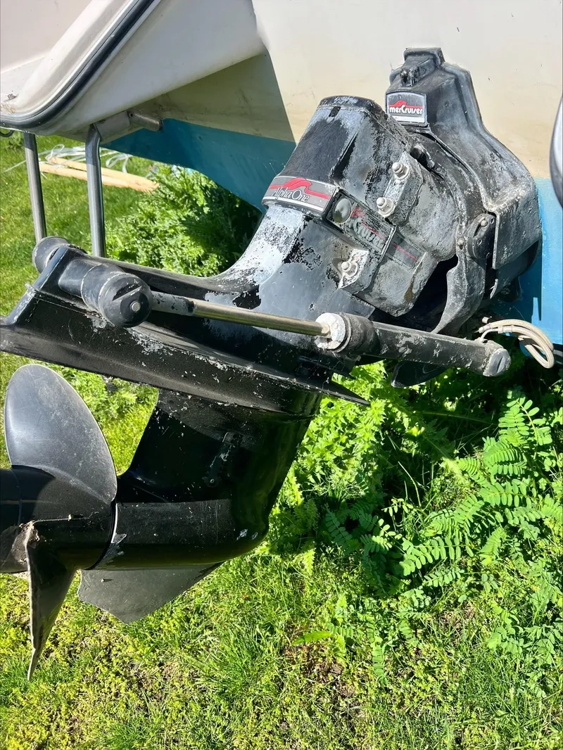 Slide: The Image of 1988 Sea Ray Sierra boat outdrive on grassy surface. - 10