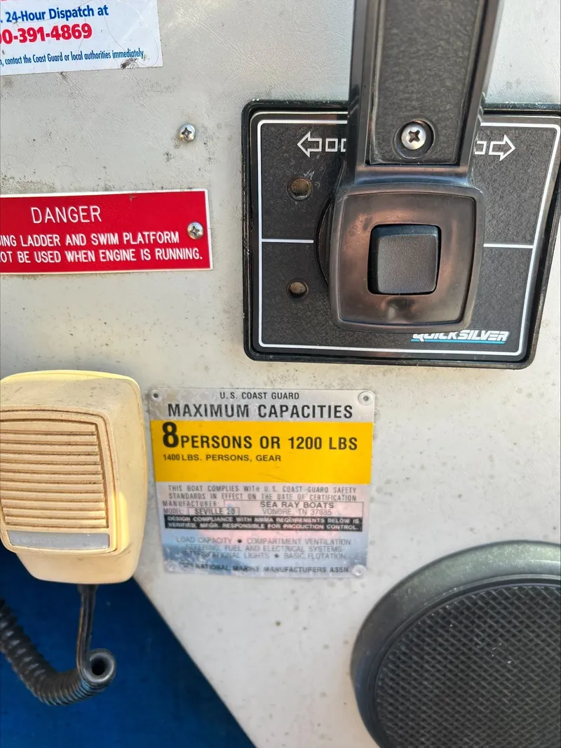 Slide: The Image of 1988 Sea Ray Sierra boat control panel with capacity warning labels and safety instructions. - 11