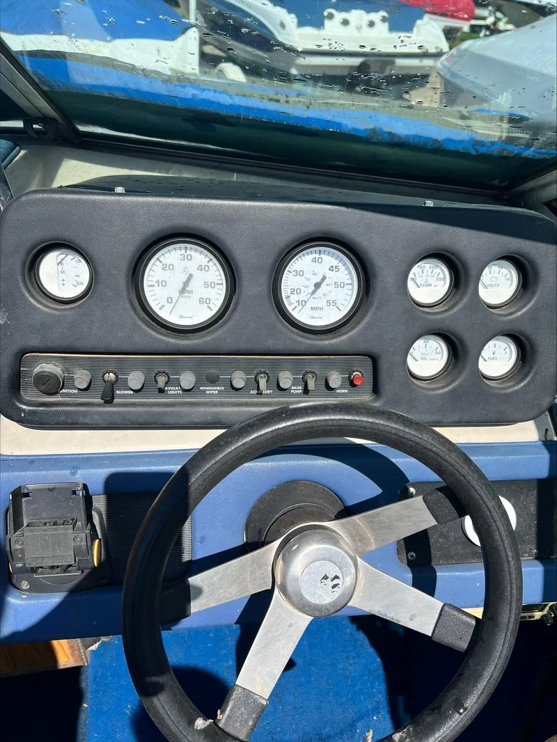 Slide: The Image of 1988 Sea Ray Sierra boat dashboard with gauges and steering wheel. - 5