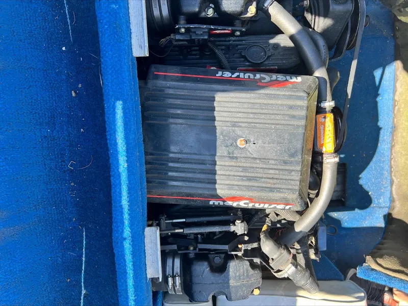 Slide: The Image of 1988 Sea Ray Sierra engine compartment with MerCruiser engine, blue interior. - 8