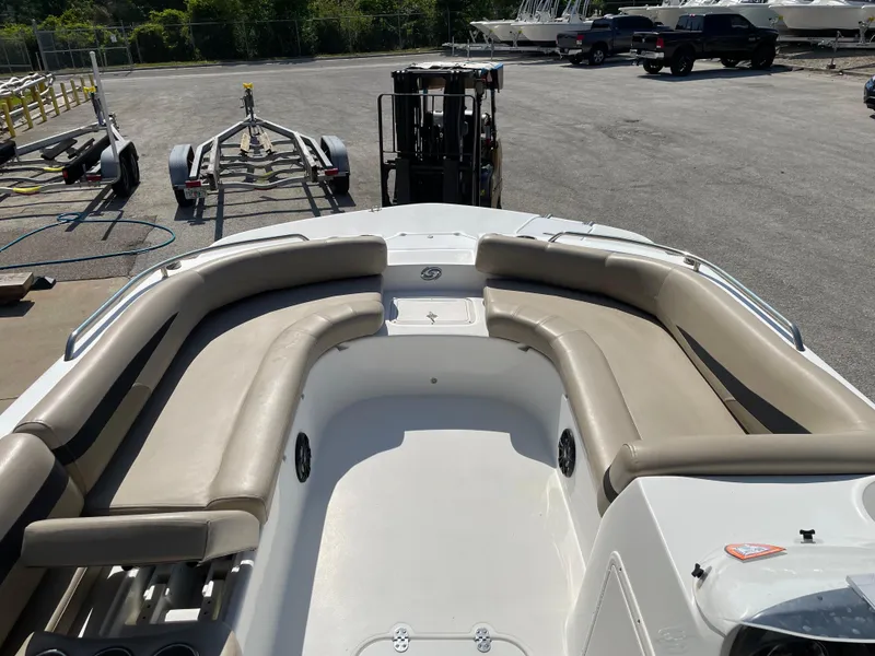 Slide: The Image of 2021 Hurricane SunDeck Sport 201 OB boat with spacious seating, parked on a trailer. - 11