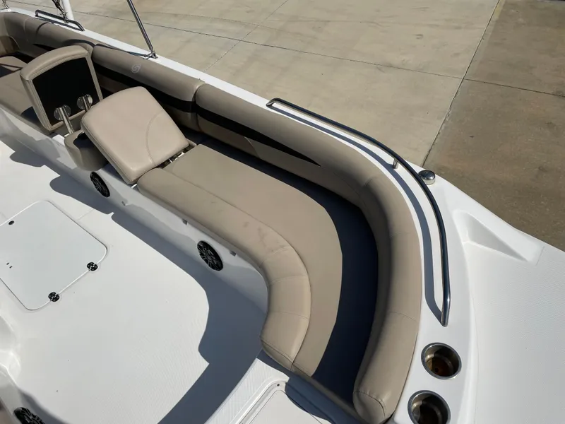 Slide: The Image of 2021 Hurricane SunDeck Sport 201 OB boat interior with beige seating and cup holders. - 14
