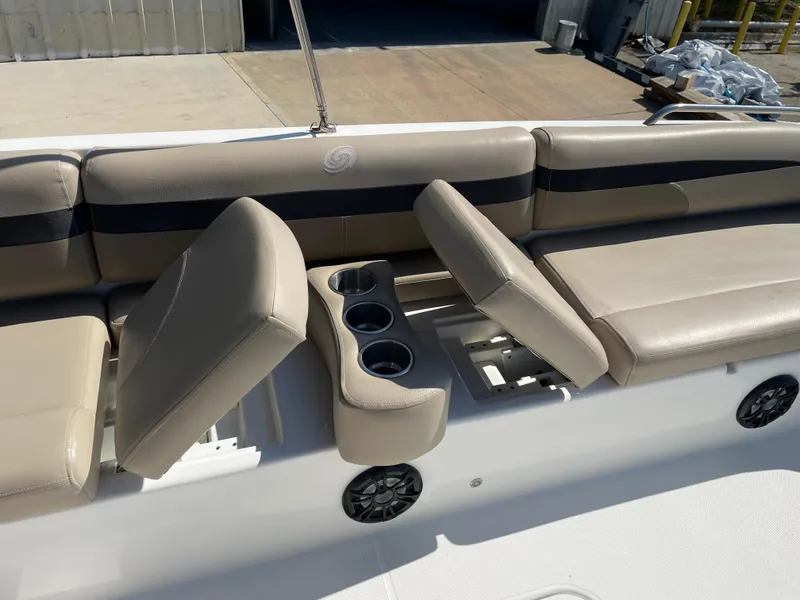 Slide: The Image of 2021 Hurricane SunDeck Sport 201 OB boat interior with beige seating and cup holders. - 16