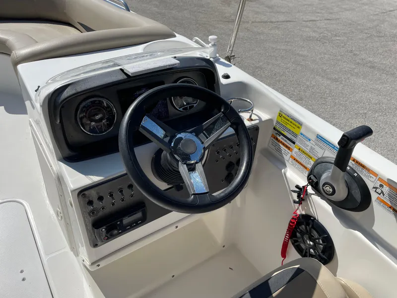 Slide: The Image of 2021 Hurricane SunDeck Sport 201 OB boat dashboard with steering wheel and controls. - 20