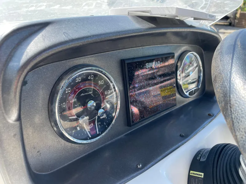 Slide: The Image of Dashboard of 2021 Hurricane SunDeck Sport 201 OB boat with speedometer and display. - 21