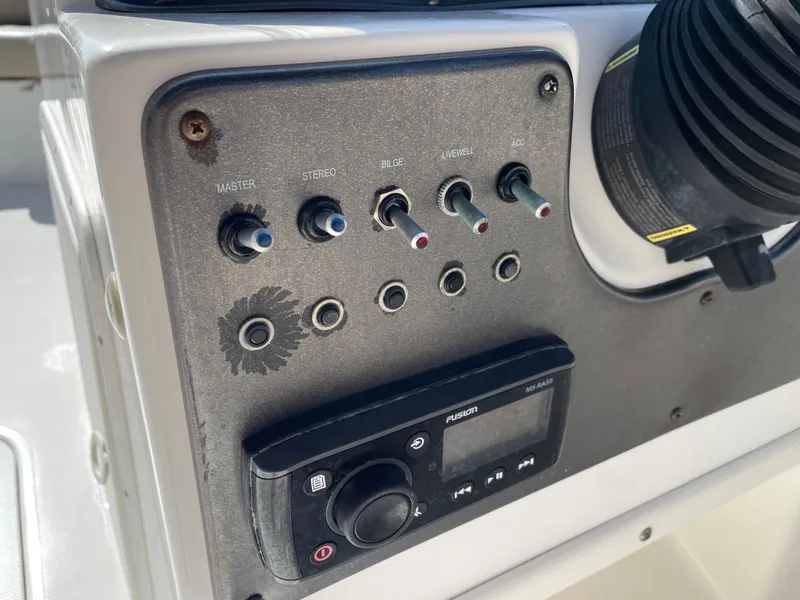 Slide: The Image of Control panel of 2021 Hurricane SunDeck Sport 201 OB boat with switches and radio. - 22