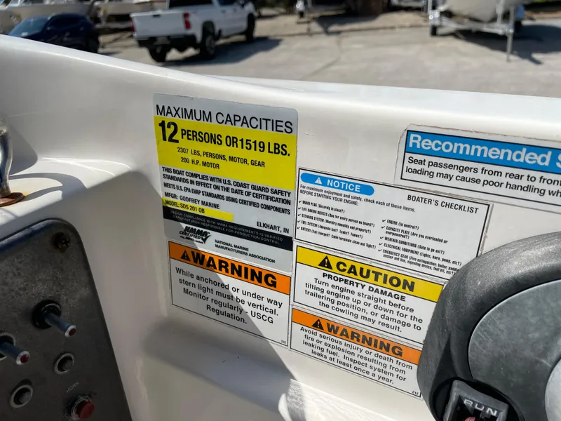 Slide: The Image of 2021 Hurricane SunDeck Sport 201 OB capacity and safety labels, maximum 12 persons or 1519 lbs. - 24