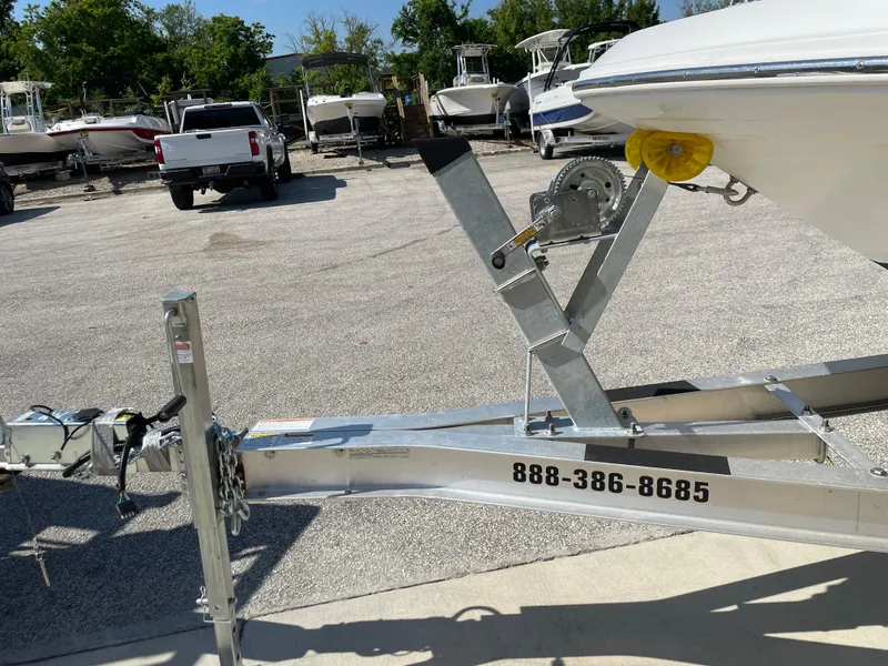 Slide: The Image of 2021 Hurricane SunDeck Sport 201 OB boat on trailer in parking lot. - 27