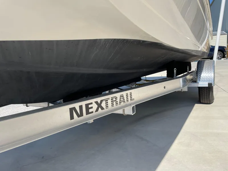 Slide: The Image of 2021 Hurricane SunDeck Sport 201 OB on NexTrail trailer, close-up view. - 28