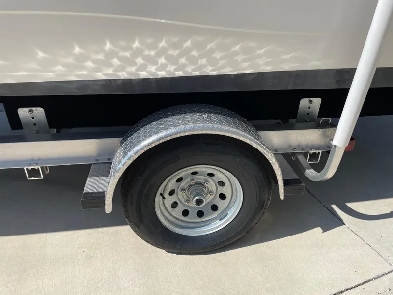 Slide: The Image of Trailer wheel of 2021 Hurricane SunDeck Sport 201 OB boat on concrete surface. - 29