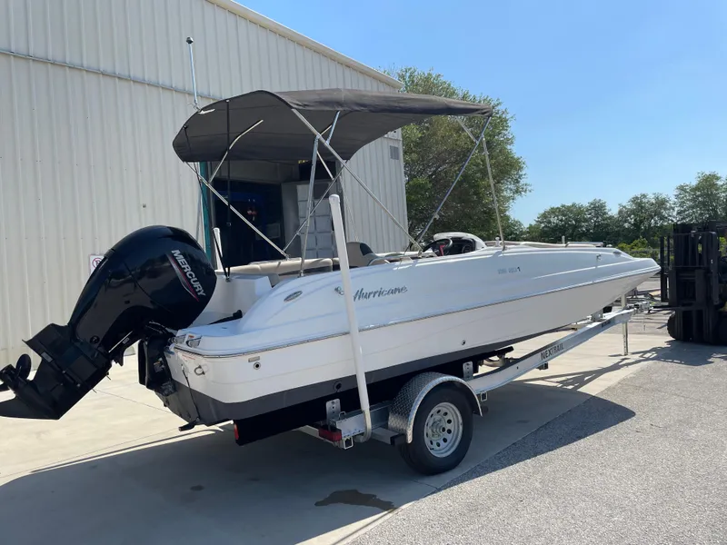 Slide: The Image of 2021 Hurricane SunDeck Sport 201 OB boat on trailer, parked outdoors. - 3