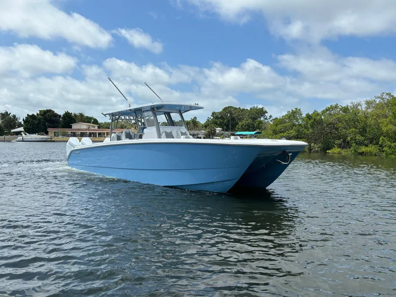 Slide: The Image of 2024 Invincible 40 Catamaran on calm water with blue sky background. - 1