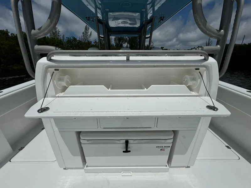 Slide: The Image of 2024 Invincible 40 Catamaran fishing station with storage compartments and cooler. - 10