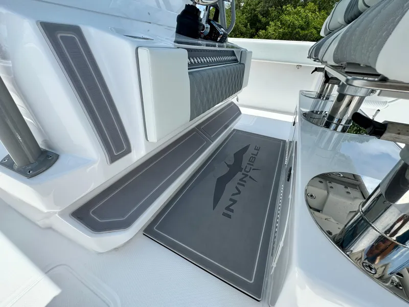 Slide: The Image of 2024 Invincible 40 Catamaran deck with branded mat and seating area. - 15