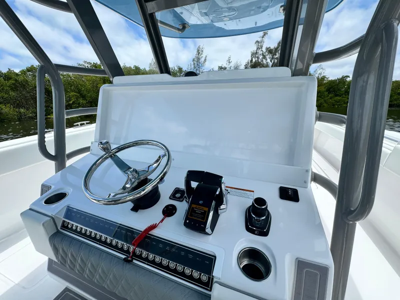 Slide: The Image of 2024 Invincible 40 Catamaran helm station with steering wheel and controls. - 16