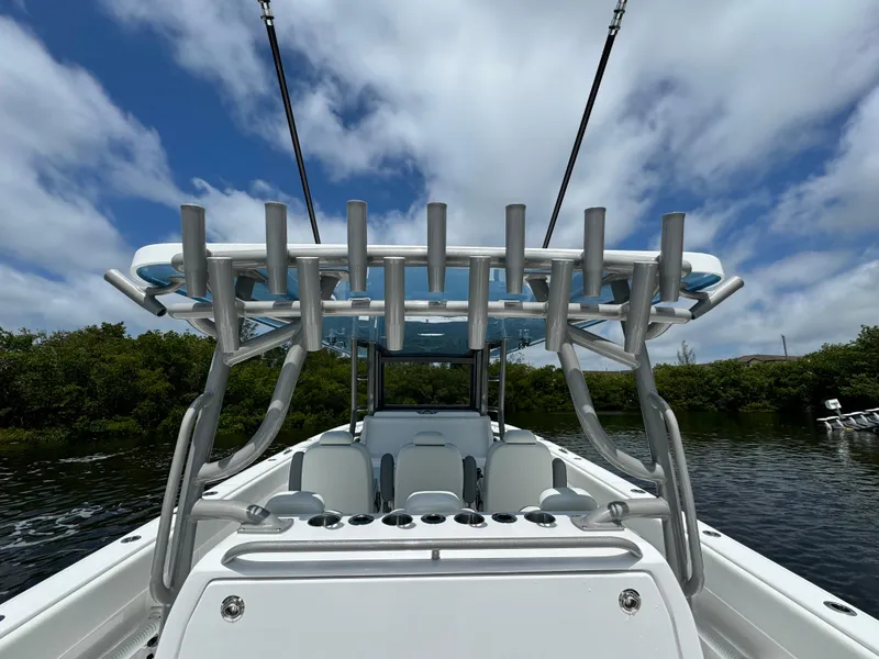 Slide: The Image of 2024 Invincible 40 Catamaran boat with rod holders and seating, on a sunny day. - 18