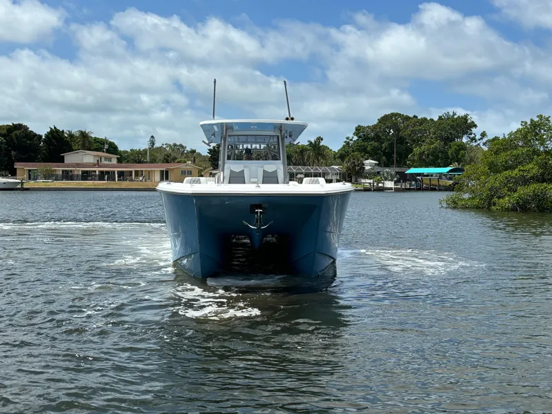 Slide: The Image of 2024 Invincible 40 Catamaran on water, front view. - 2