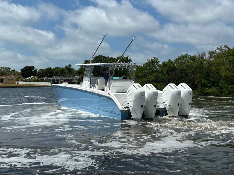 Slide: The Image of 2024 Invincible 40 Catamaran with quad engines cruising on water. - 4