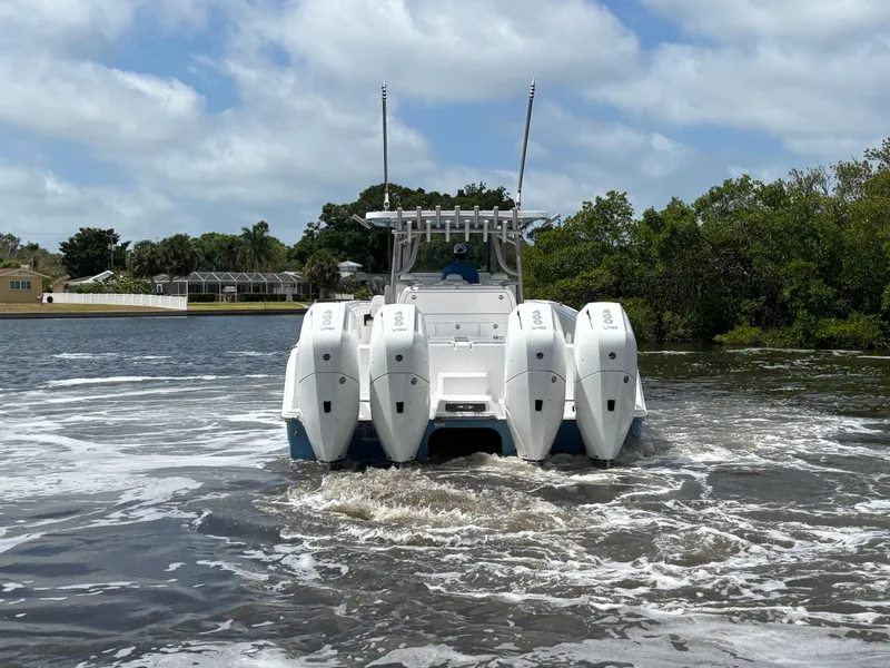 Slide: The Image of 2024 Invincible 40 Catamaran with quad outboard engines on the water. - 5