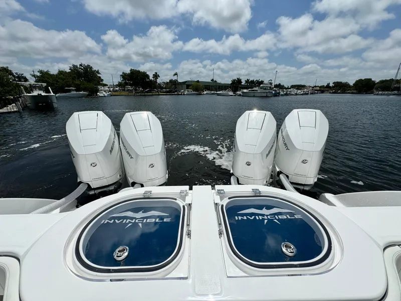 Slide: The Image of 2024 Invincible 40 Catamaran with quad outboard engines on the water. - 6