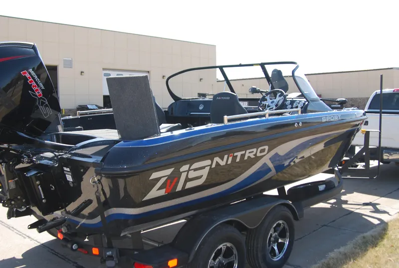 Slide: The Image of 2024 Nitro ZV19 Sport Pro boat on trailer, sleek design, powerful engine. - 2