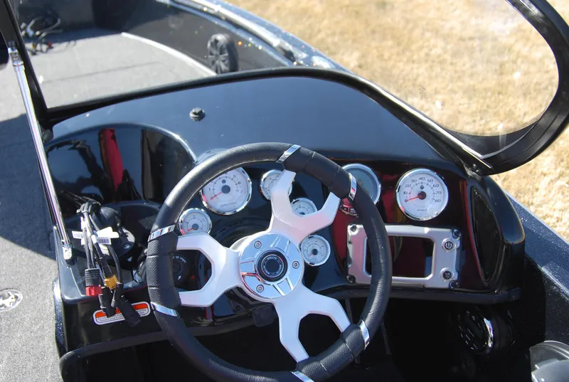 Slide: The Image of 2024 Nitro ZV19 Sport Pro boat dashboard with steering wheel and gauges. - 8