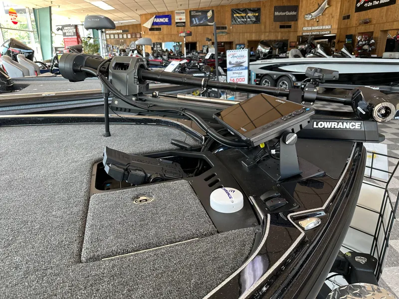 Slide: The Image of 2024 Triton 20XP Patriot boat with Lowrance electronics in showroom. - 3