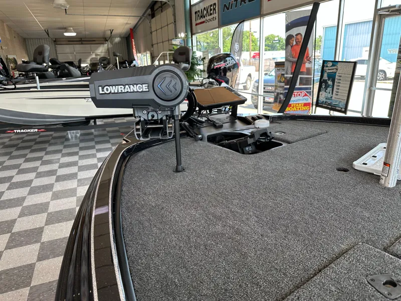 Slide: The Image of 2024 Triton 20XP Patriot boat with Lowrance equipment in showroom. - 5