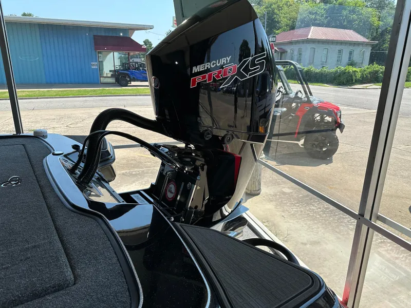 Slide: The Image of 2024 Triton 20XP Patriot boat with Mercury Pro XS engine in a showroom. - 6