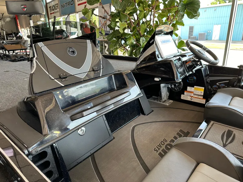 Slide: The Image of 2024 Triton 20XP Patriot boat interior with modern dashboard and seating. - 7