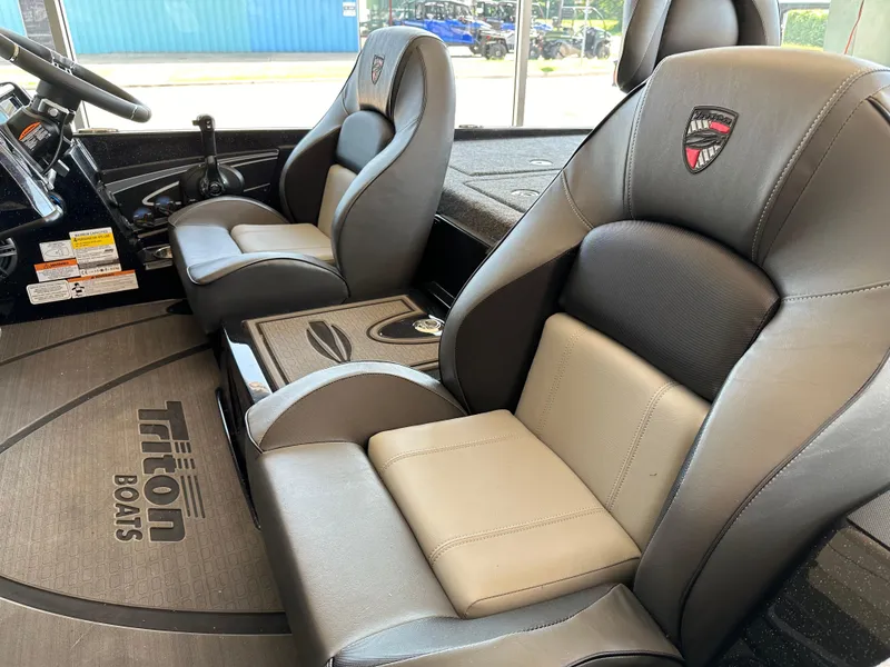 Slide: The Image of 2024 Triton 20XP Patriot boat interior with premium seating and console. - 8