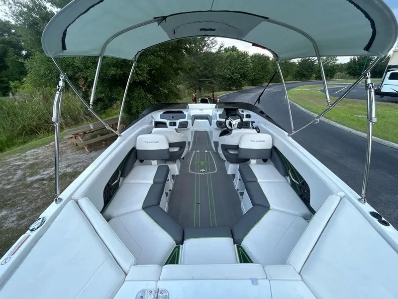 Slide: The Image of 2023 Tahoe 210 S Limited boat interior with canopy, spacious seating, and modern design. - 4
