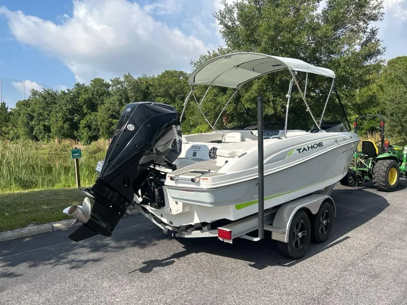 Slide: The Image of 2023 Tahoe 210 S Limited boat on trailer with outboard motor. - 6