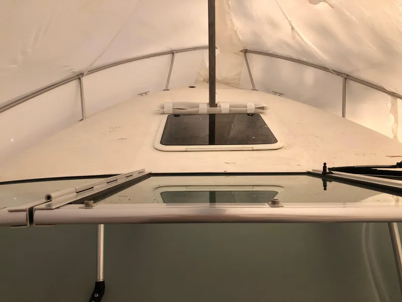 Slide: The Image of 1994 Sea Ray Overnighter boat interior with windshield and hatch. - 11